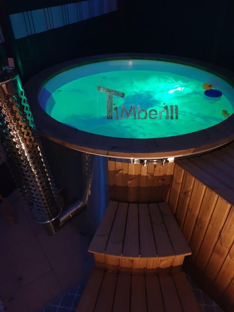 Electric hot tub installation with enclosed pumps, heater, lighting and controls
