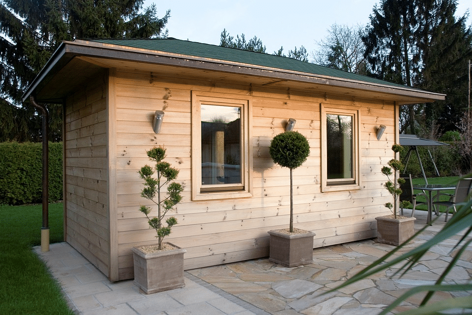 Traditional outdoor sauna showing stone heater, upper benches and planned airflow
