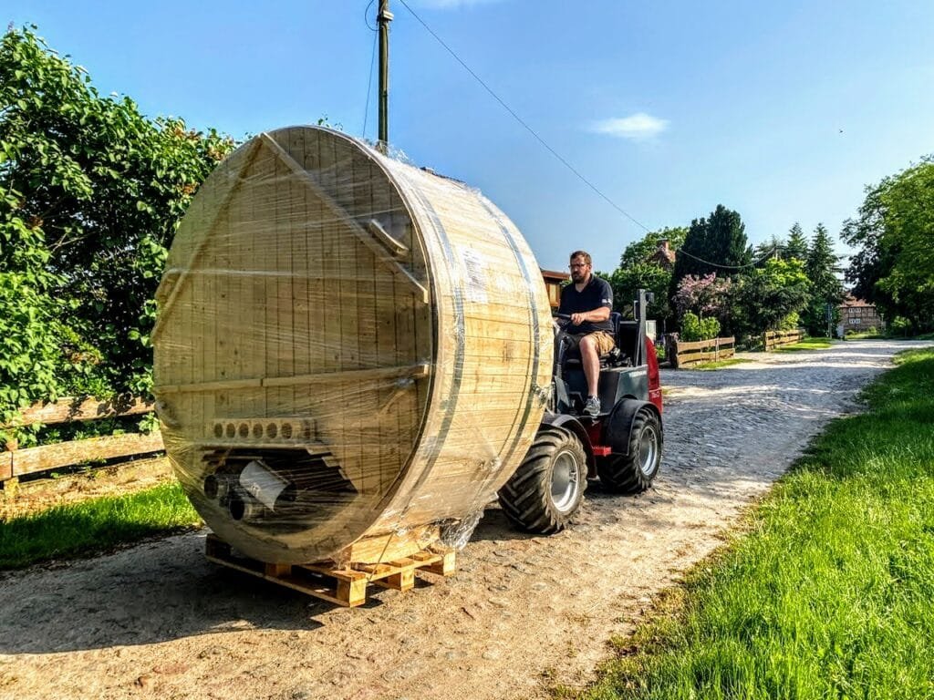 Packaged hot tub being unloaded with a forklift at the agreed delivery point