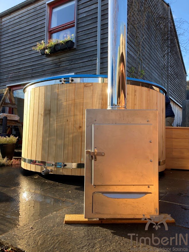 Large wooden hot tub with an external wood-fired heater and separate service space