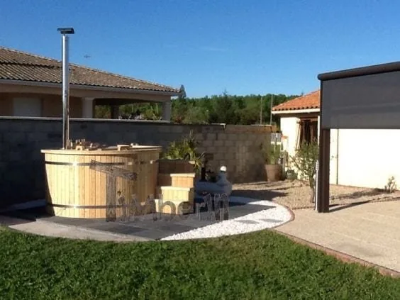 Preparing the Base for a Hot Tub or Outdoor Sauna 2 Round timber hot tub on a paved garden base with a drained gravel border beside a terrace
