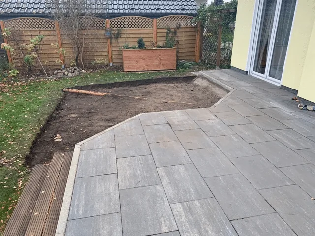 Preparing the Base for a Hot Tub or Outdoor Sauna 6 Marked hot-tub base area beside an existing terrace with part of the topsoil excavated