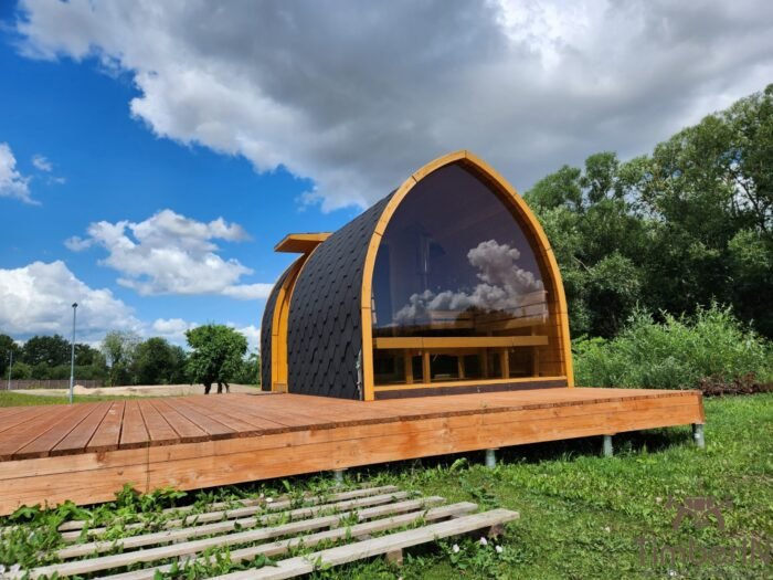 Modern outdoor glass sauna pod in Ireland on large wooden terrace with panoramic front window