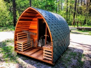 outdoor sauna in British garden surrounded by trees and morning steam