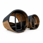 TimberIN Nordic Barrel Panorama™ – panoramic barrel sauna with dark shingle shell, curved full-glass front, central glass door and visible timber benches on a white background.