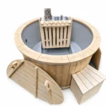 TimberIN Nordic Compact™ Snorkel – compact round wooden hot tub with grey liner, internal snorkel stove, protective timber guard, chimney and wooden access deck on a white background.