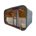 TimberIN Nordic Horizon™ – contemporary garden sauna cabin with rounded dark roof, panoramic glass front, central door and visible tiered timber benches on a white background.