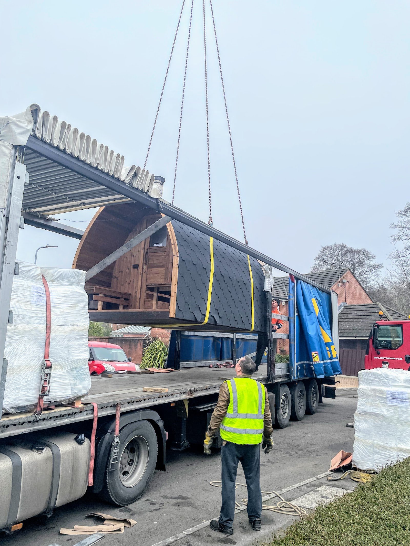 TimberIN UK 15 Barrel sauna being lifted by crane from a delivery lorry