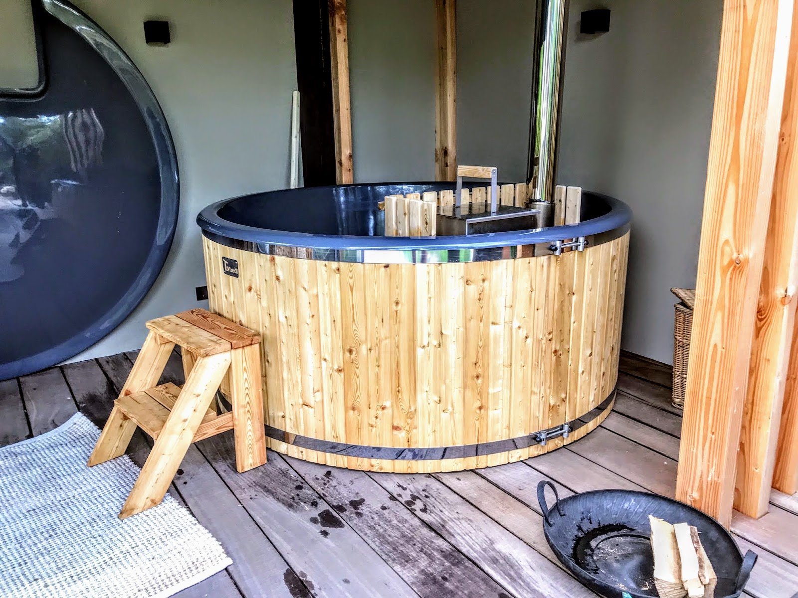 TimberIN UK 13 Timber hot tub with an internal stove under a roof