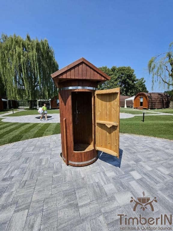 Small 1 Upright timber sauna with its door open onto a paved approach