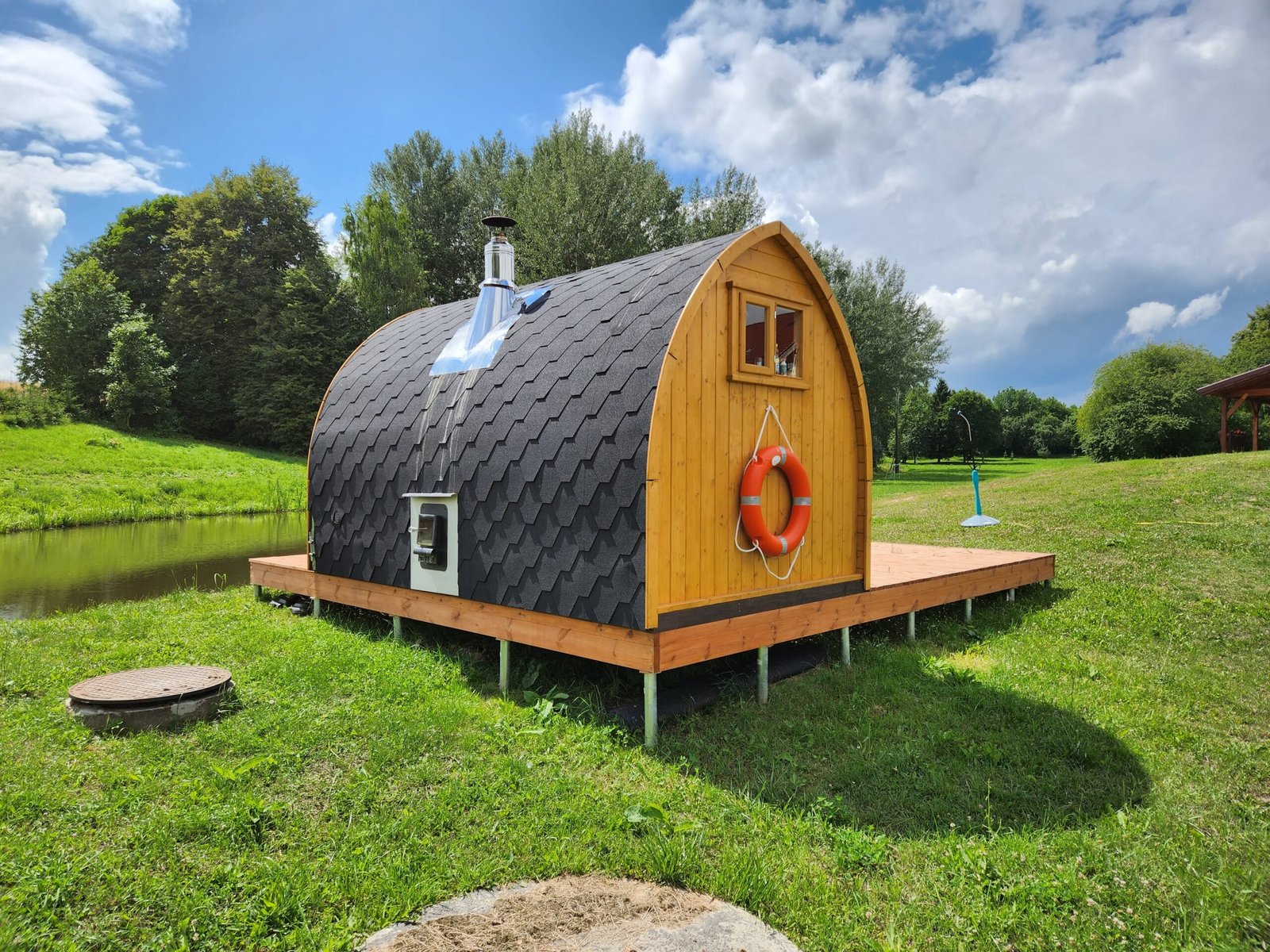 Outdoor Saunas in Birmingham: Urban Garden Buying Guide 1 Pod sauna with external heater access, roof chimney and surrounding timber platform