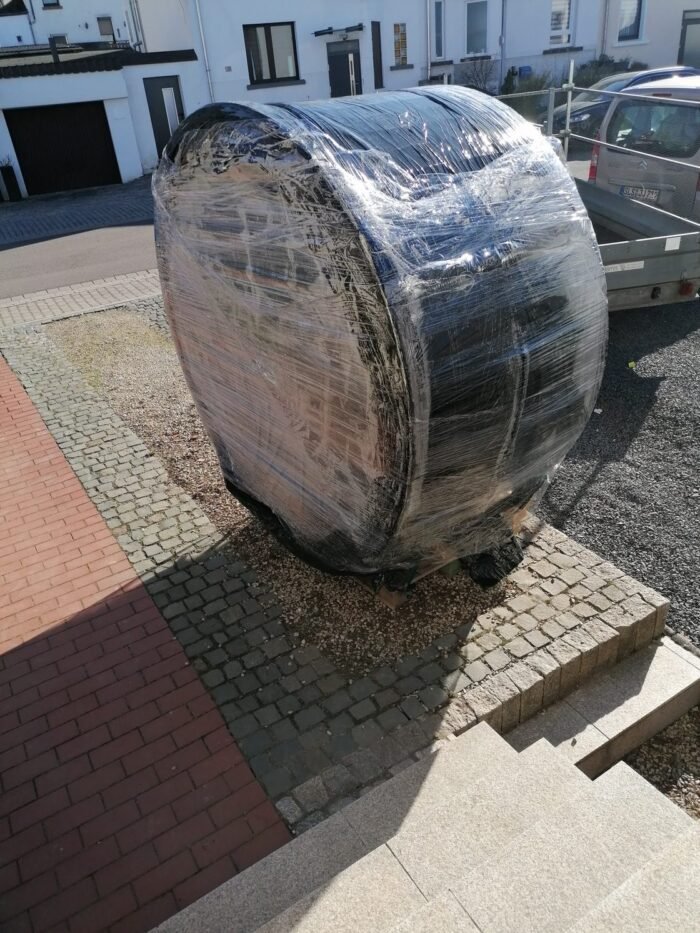 Wrapped round hot tub positioned on its side for delivery