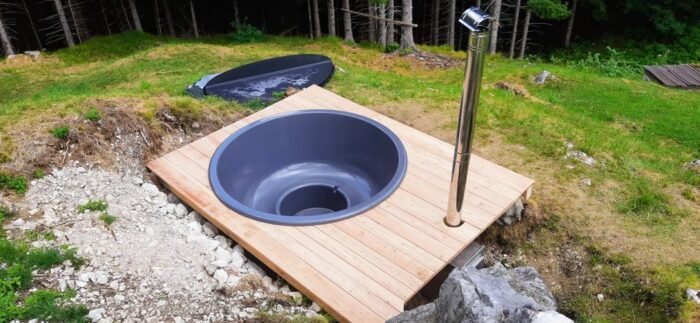 Empty moulded hot tub shell recessed into a timber deck