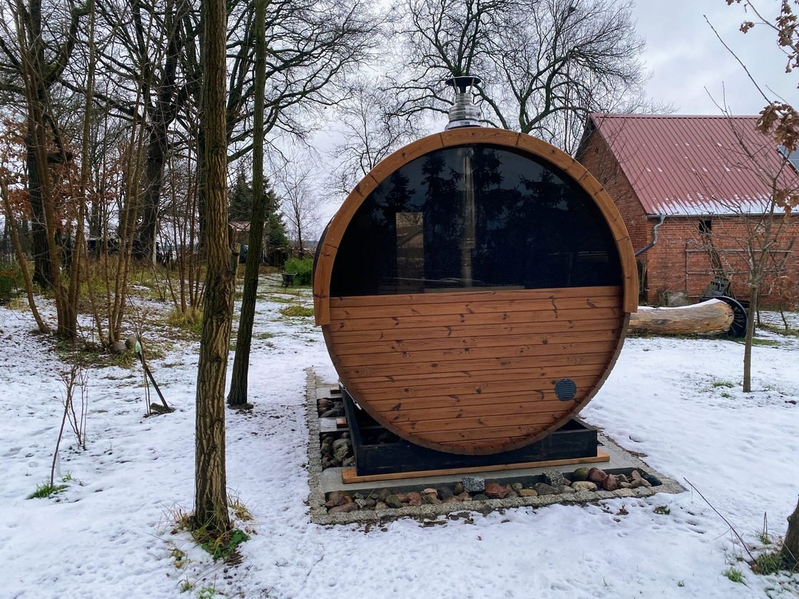 Barrel sauna in a snow-covered garden