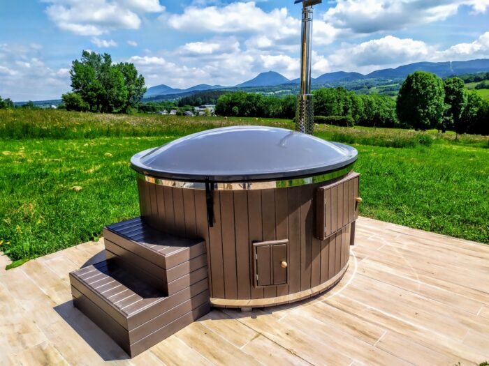 Round wooden hot tub with brown WPC cladding