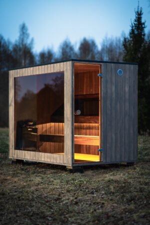 TimberIN Nordic Cube outdoor sauna glass front at dusk