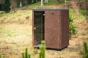 TimberIN Nordic Cube S outdoor sauna in a garden