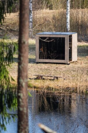 TimberIN Nordic Cube sauna by a pond