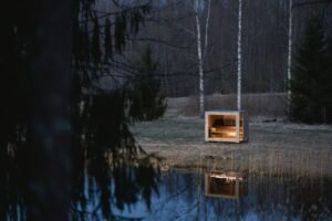 TimberIN Nordic Cube sauna in a meadow
